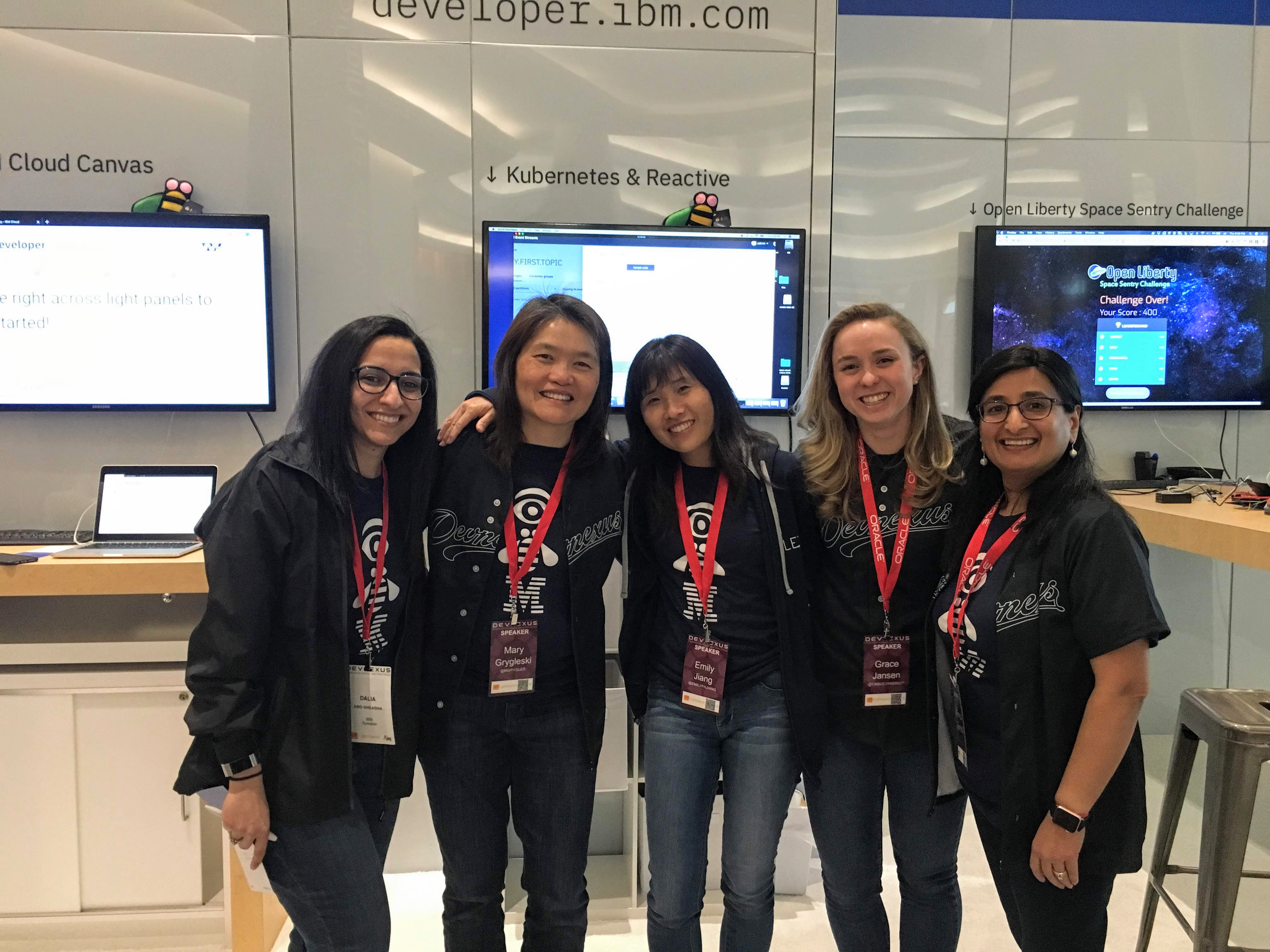 Photo of Monica with colleagues at a conference booth